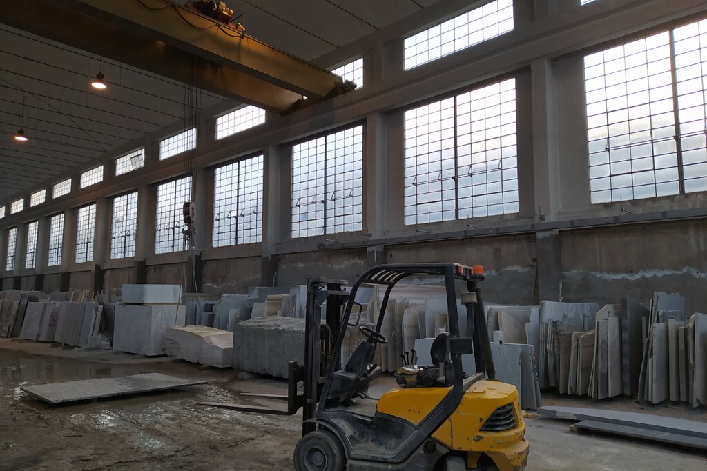Internal combustion forklift parked inside a large industrial warehouse