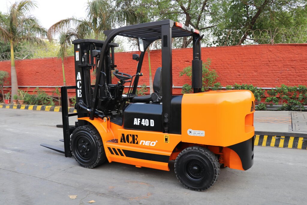 Orange internal combustion forklift parked outdoors on a paved lot